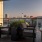 covered, rooftop patio with tables and chairs and views of downtown