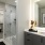 a bathroom with a glass, walk-in shower and walk-in closet access