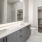 a bathroom with a large, backlit mirror